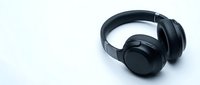 Black wireless headphones isolated on white background for music listening and audio entertainment technology designs.