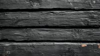 Dark weathered wooden planks with rough textured surface and natural grain pattern create rustic background for design projects and vintage style compositions.