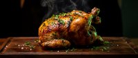 Roasted whole chicken with golden crispy skin and herbs on wooden cutting board with steam rising, ready to serve for family dinner or holiday meal.