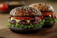 Juicy beef burger with melted cheese, crispy bacon, fresh lettuce on black sesame bun served on wooden board, close up view of gourmet fast food.