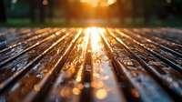 Wet wooden deck planks reflecting golden sunset light with water droplets creating magical bokeh effect. Close-up perspective leads to glowing horizon.