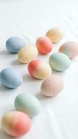 Colorful speckled Easter eggs in soft pastel shades scattered on white background for spring holiday decorations and seasonal celebrations.