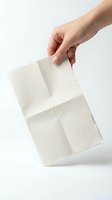 Hand holding white paper shopping bag on clean background for retail and commercial design projects.