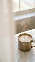 Steaming hot coffee cup with latte art on wooden table by window in cozy cafe atmosphere for morning relaxation and comfort lifestyle concepts.