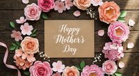 Happy Mother's Day card surrounded by pink and peach paper roses with petals on rustic wooden background for greeting cards and celebrations.