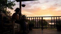 Silhouetted couple sitting on wooden deck at sunset overlooking water, hanging plants, romantic evening atmosphere, relaxation and togetherness concept for lifestyle and relationship themes.