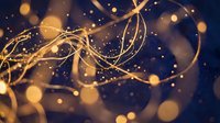 Elegant golden ribbons flowing with sparkling bokeh lights on dark blue background for luxury celebrations and festive decorations.