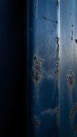 Weathered blue metal surface with rust stains and corrosion marks, showing aged industrial texture and decay patterns suitable for grunge backgrounds and worn material design elements.