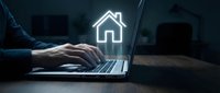 Professional working on laptop with glowing house icon representing real estate technology, property management software, or home buying services online.
