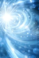 Swirling blue energy vortex with glowing light burst and floating bokeh particles creates magical atmospheric background effect for spiritual designs.