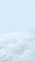 Closeup of sparkling white snow crystals with soft blue-tinted light, creating a serene winter landscape. Suitable for seasonal marketing, holiday campaigns, and winter-themed designs.