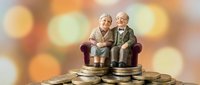 Elderly couple sitting on stack of coins representing retirement savings and financial security planning for senior years with warm bokeh background.
