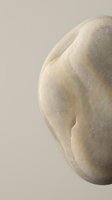 Close-up of smooth weathered stone with natural curves and texture on neutral background for spa wellness meditation zen minimalist design concepts.