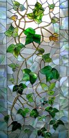 Stained glass window with climbing ivy pattern featuring emerald green leaves on winding bronze vines against opalescent background. Suitable for architectural design.