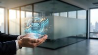 Businessman hand holding holographic risk management interface with data analytics in modern office environment for financial planning and assessment.