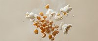 Floating eggs and eggshells with white splashes on beige background. Dynamic food photography concept for cooking, baking and breakfast recipes.
