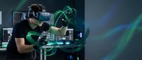 Young man experiencing virtual reality gaming with VR headset and controllers in futuristic tech environment with green digital effects and modern setup.