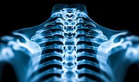 Glowing blue x-ray scan of human cervical and thoracic spine vertebrae showing detailed skeletal anatomy against black background for medical visualization.