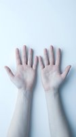 Two open human palms raised against a light blue background, showing veins and skin texture, symbolizing surrender, openness, or help.