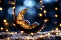 Magical glowing golden crescent moon with twinkling star lights on dark blue bokeh background, creating dreamy celestial atmosphere for holiday decorations.