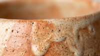 Handmade ceramic pottery bowl with natural terracotta texture and organic speckled surface finish for rustic home decor and artisan crafts.