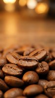 Roasted coffee beans close-up with warm bokeh background for cafe menu design and beverage advertising materials.