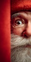 Elderly Caucasian man with white beard and red knit hat peeking from behind red wall with curious expression for holiday marketing and seasonal campaigns.