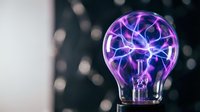 Plasma ball with purple and blue electric filaments glowing inside glass sphere against blurred dark background, representing innovation, energy, and technology concepts.