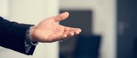 Caucasian male hand in business suit with watch extended in welcoming gesture, suitable for corporate presentations, leadership concepts, and professional communication materials.