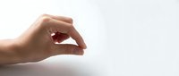 Caucasian hand gesturing small size measurement against white background, isolated for design use on marketing materials and presentations.