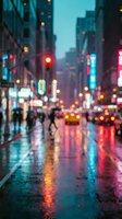 Blurry rainy city street at night with glowing neon lights reflecting on wet pavement, bokeh traffic and pedestrians in urban scene.