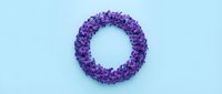 Purple virus particle with spiky protein surface isolated on light blue background for medical education and scientific research presentations.