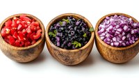 Fresh diced vegetables in wooden bowls - red tomatoes, black olives, and purple onions arranged in row on white background for cooking preparation.