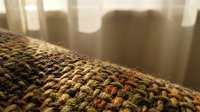 Close-up of woven fabric texture with warm earth tones and natural fibers, suitable for interior design, textile backgrounds, and home decor projects.