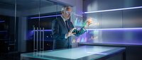 Mature male professional in business suit analyzing holographic data charts and financial graphs in modern office environment for corporate analytics and technology solutions.