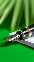Luxury fountain pen with gold-plated nib on white paper against green background, macro shot showing intricate details and metallic accents for business and writing.