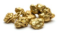Raw gold nuggets collection showcasing natural metallic luster and rough texture isolated on white background for mining industry designs.