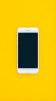White smartphone with blank dark screen isolated on bright yellow background, ready for app mockups and mobile technology designs.