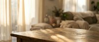 Warm sunlight streaming through sheer curtains illuminates rustic wooden table surface in cozy living room interior with soft furnishings and natural lighting.