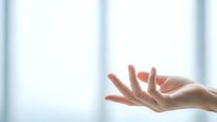 Open female hands reaching upward in soft natural light with blurred window background, conveying hope, prayer, receiving and spiritual connection.