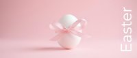 White Easter egg with a delicate pink ribbon bow on a soft pink pastel background, minimalist holiday concept for spring greeting cards.