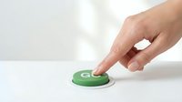 Hand pressing green button with play symbol on white surface, isolated for design use on websites, apps, applications, and marketing materials.