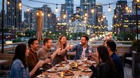 Group of diverse young adults enjoying dinner party on urban rooftop terrace with string lights and city skyline at twilight for social gatherings.