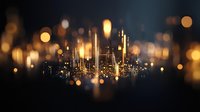Glowing cityscape silhouette with golden bokeh lights and reflections creating magical urban nightscape atmosphere against dark background. Perfect for business presentations.