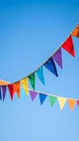 Colorful bunting flags strung across clear blue sky, perfect for festive celebrations, parties, events, and outdoor decorations.