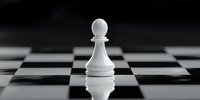 White chess pawn on checkered board with reflection, dramatic lighting creates contrast between light piece and dark background in minimalist composition.