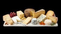 Assorted cheese board with grapes, nuts, and dried fruits, isolated on transparent background. Ready for food menus, print on demand, stickers, and T-shirt design use.