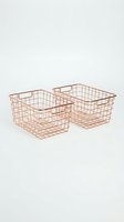 Two rose gold wire storage baskets with handles isolated on white background for home organization and decor projects.