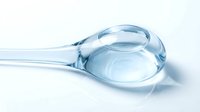 Transparent glass pipette with water droplet on white background, isolated for medical, scientific, laboratory, and healthcare design applications.