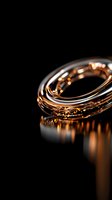 Luxurious rose gold metallic spiral rings with reflective surface on black background create elegant abstract composition with dramatic lighting and shadows.